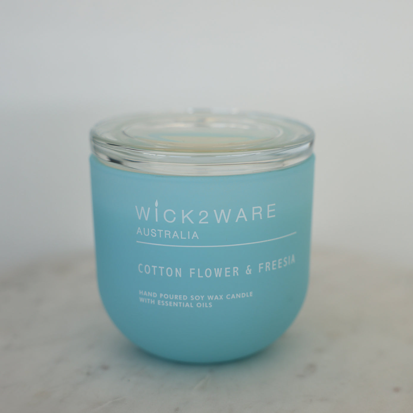 Cotton Tree & Freesia candle with lid on – hand-poured soy wax candle in matte glass vessel