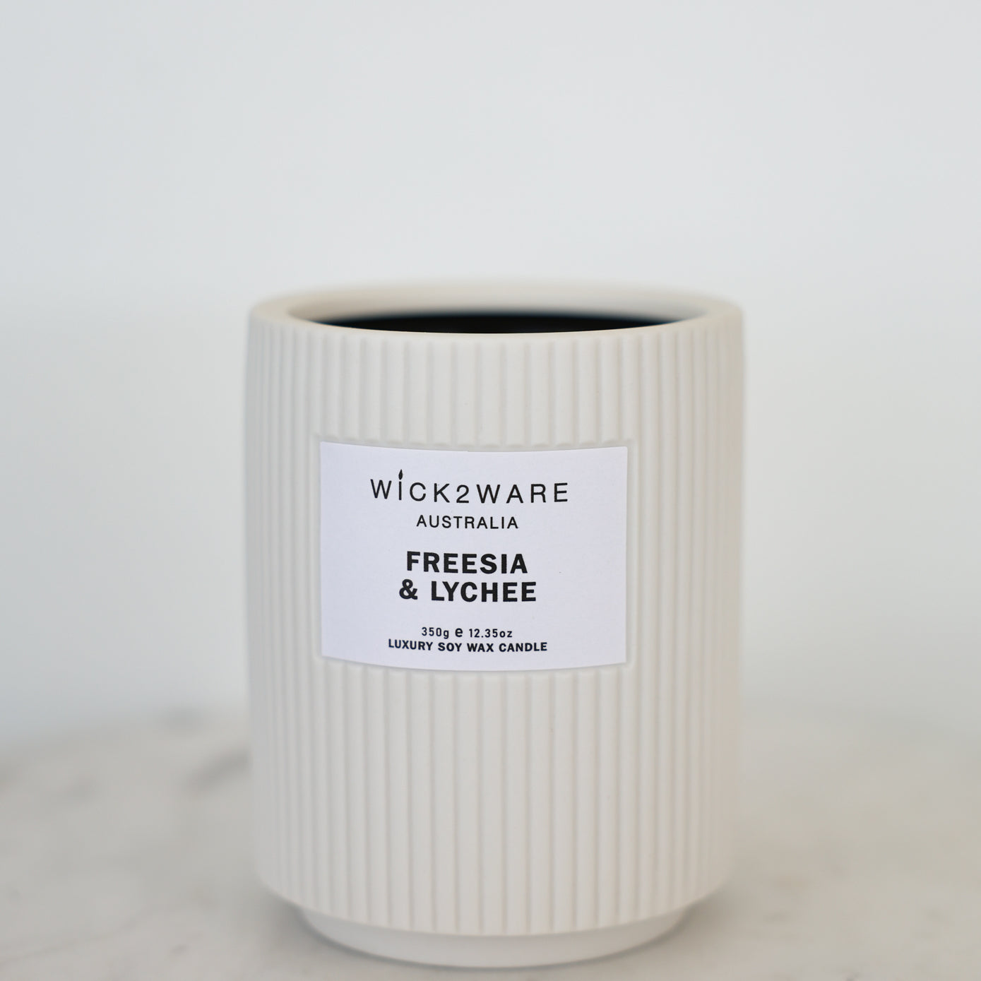 Freesia & Lychee candle in white ribbed ceramic jar – single wick, no lid